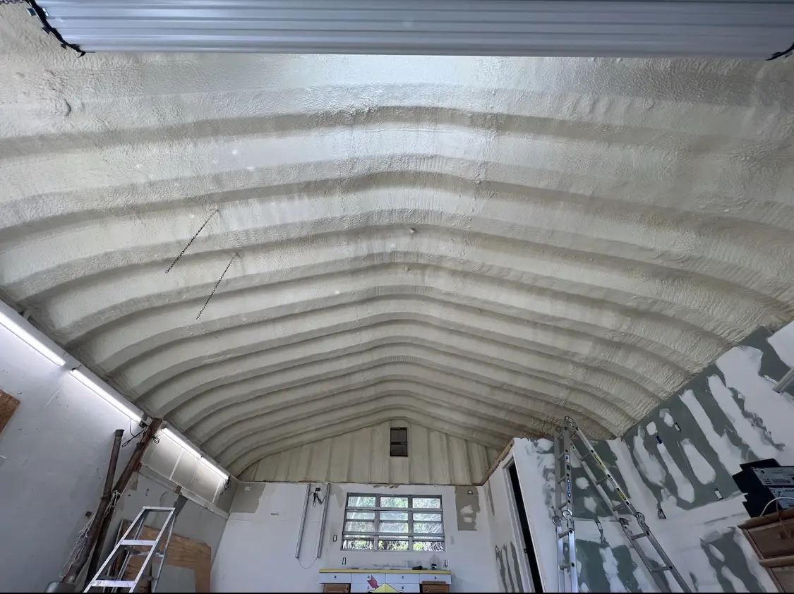 Spray polyurethane foam applied to the underside of a metal roof deck in Mandan
